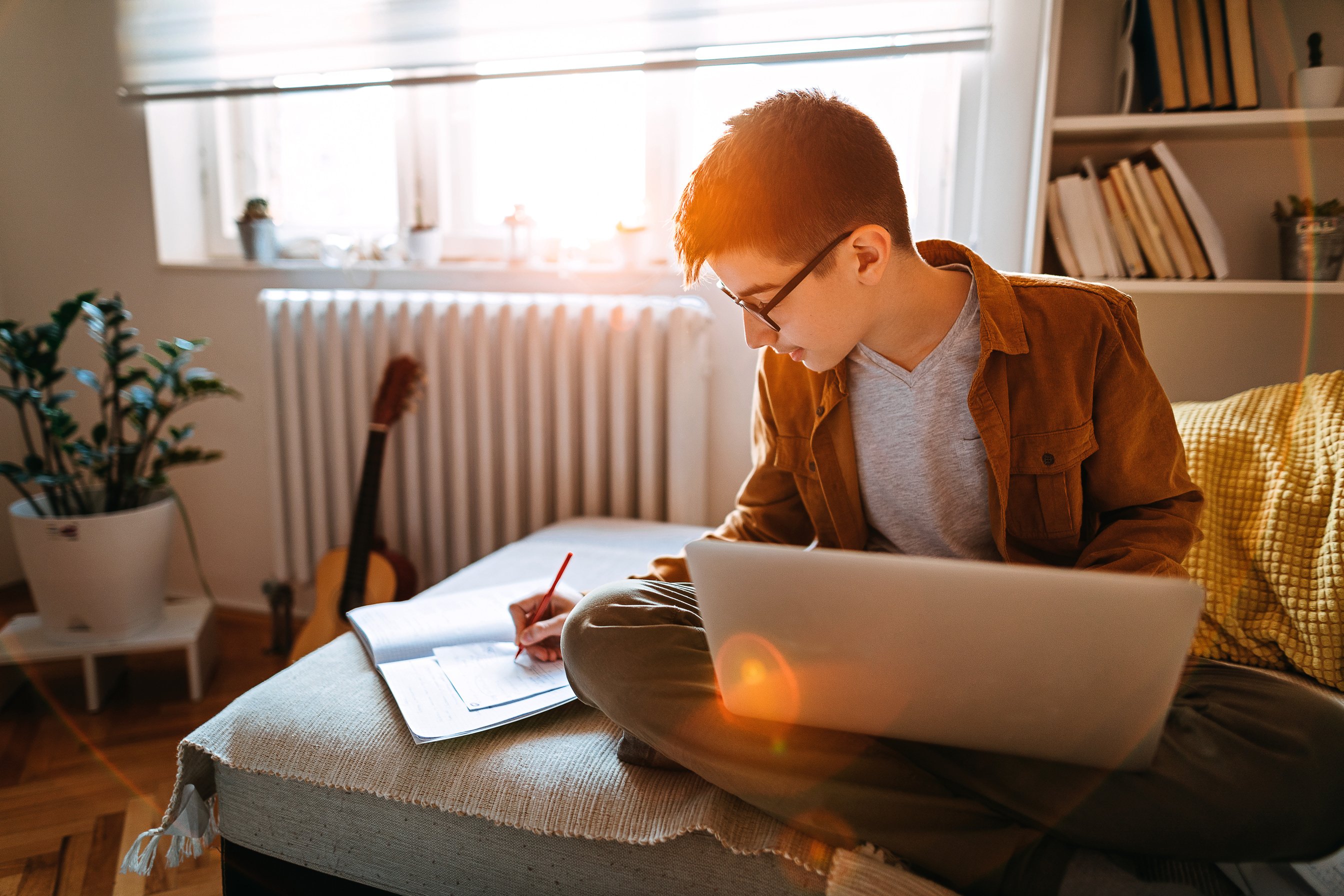 Teenage boy attending to online school class